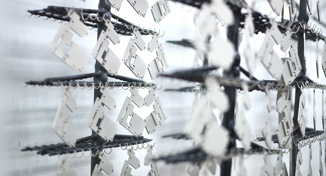 Tin components hanging on a rack